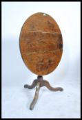 A 19th century mahogany circular tilt top loo table raised on circular base with  hoof feet having