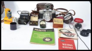 A vintage 20th Century cased Braun Super Paxette Outfit. Comprising camera with lenses, various