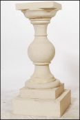 A 20th century Bath Stone plinth of neo-classical form having 3 parts, turned column centre