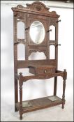 A Victorian 19th century Jacobean Revival solid carved oak  hall stand. Raised on carved square