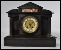 A Victorian polished slate mantel clock with enamel and gilt metal dial. The brass 8 day movement