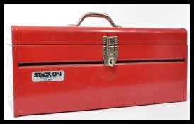 A vintage 20th century red vitreous enamel toolbox containing a group of vintage tools. Tools to