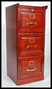 A contemporary antique style mahogany 3 drawer filing cabinet with brass handles and paper slides.