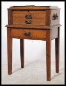A good Edwardian Arts & Crafts oak cased canteen of cutlery on stand. The stand with squared legs an