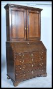 A 19th Century Georgian mahogany bureau bookcase, the upper shelved bookcase with a short cornice