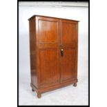 Holdall - A 1930's oak compactum wardrobe having a haberdashery style appointed interior and twin