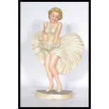 A cast metal doorstep in the form of a figure of Marilyn Monroe in the iconic pose. Measures 34 cm