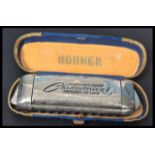 A vintage 20th Century Art Deco cased M. Hohner Chromonica I De - Luxe harmonica. Measures 15 cm