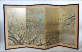 A 20th century Japanese four fold discretionary screen having a hand painted scene flowing