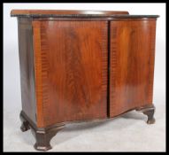 A 20th century Georgian revival serpentine fronted mahogany sideboard of small proportions. Raised