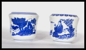 Two 19th century Chinese blue and white brush / water pots decorated with traditional scenes and