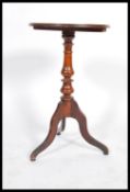 A 19th century early Victorian solid mahogany wine / lamp table raised on tripod base with