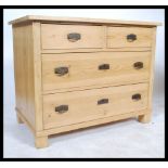 A 20th Century Scandinavian pine two short over two long chest of drawers having pressed metal art