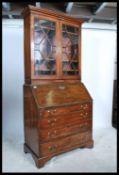 A 19th century Georgian mahogany bureau bookcase having appointed bureau over chest beneath and
