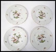 A group of four Herend porcelain cabinet plates hand painted in the Rothschild Birds pattern with