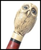 A 20th Century walking cane mounted with an Owl above a tapering shaft. Measures 93 cm high.