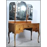 A 20th century Edwardian walnut dressing table having an arrangement of drawers with a three fold