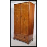 A 1930's Art Deco walnut single wardrobe  armoire in the manner of Compactom. The robe being