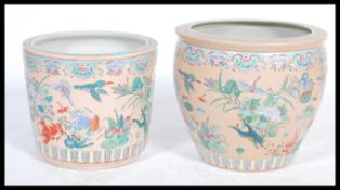 A near pair of vintage 20th century ceramic Chinese planters of large form decorated in famile