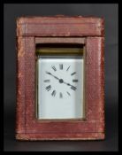 An 19th century brass carriage clock with inset French movement. Enamel face with roman numeral