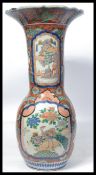 A 19th century large ceramic Japanese floor standing stick stand vase having blue and red painted