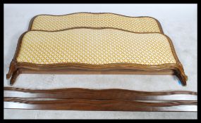 An early 20th century French corbeille bed with chenille upholstered head and footboard united by