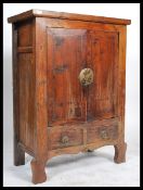 A middle Qing Dynasty period walnut chest having a series of drawers and cupboards raised on block