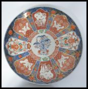 A 19th century Japanese Imari Charger of large circular form having various white cartouche panels