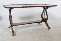 An early 20th century Regency revival Georgian style walnut coffee table raised on hairy paw feet