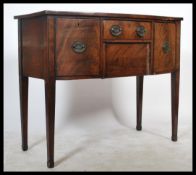 A Georgian early 19th century mahogany bow fronted  sideboard of small proportions being fitted with