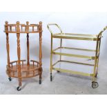 Two vintage 20th century cocktail bar drinks trolleys to include a circular wooden example and a