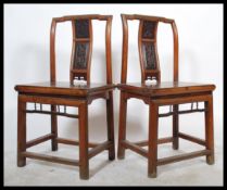 A pair of 19th century Chinese elm alter chairs from the Zhejiang province, with carving to the