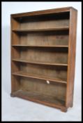 A large Victorian mahogany open window bookcase cabinet having flared top with central shelves.