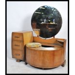 A 1930's Art Deco oak dressing table chest. The dressing table with comma shaped swing out stool