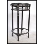 An early 20th century ebony and mother of pearl inlaid occasional table of circular form having