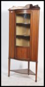 Edwardian inlaid mahogany corner display unit on tapering support with two internal shelves and a