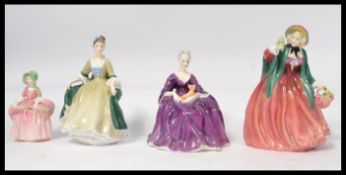 A group of four Royal Doulton figurines to include Bo Peep HN1811 , Charlotte HN2421 , Lady Charmian
