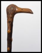 A vintage early 20th century walking stick cane having a tapering blackthorn shaft. The handle