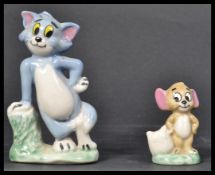 Two Wade ceramic figurines of Tom and Jerry modeled standing with makers name to rear.