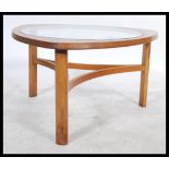 A mid 20th Century shaped triangular teak coffee table, inset with glass top, shaped rectangular