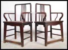 A pair of 19th century Qing dynasty Chinese beech alter / elbow chairs from the Shandong Province.