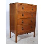 A vintage mid 20th Century oak straight chest of four graduating drawers, fitted with brass