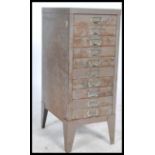 A vintage / retro industrial upright metal eight short drawer filing cabinet, shaped supports having