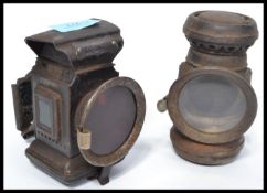 Two vintage early 20th century carbide / acetylene bike / bicycle lamps of typical form one having