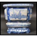 A 20th century Chinese jardiniere plant stand with blue and white decoration with geometric panels