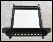 A Victorian ebonised mahogany mirror having spindle gallery over bevelled edge plate mirror with a