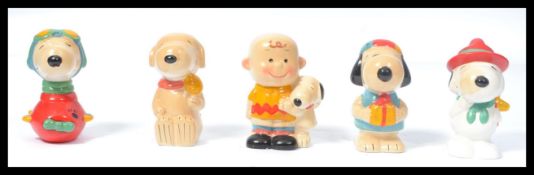 A collection of five 1960's retro ceramic money boxes modelled after Snoopy / Peanuts to include