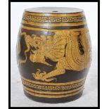 A 20th century Chinese ceramic opium stool having yellow decoration depicting dragons chasing the