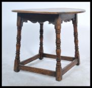 A Victorian 19th century oak tavern table. Raised on block and turned legs united by stretchers