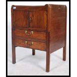 An early 19th century Georgian mahogany bedside being gallery tray top with twin door cupboard above